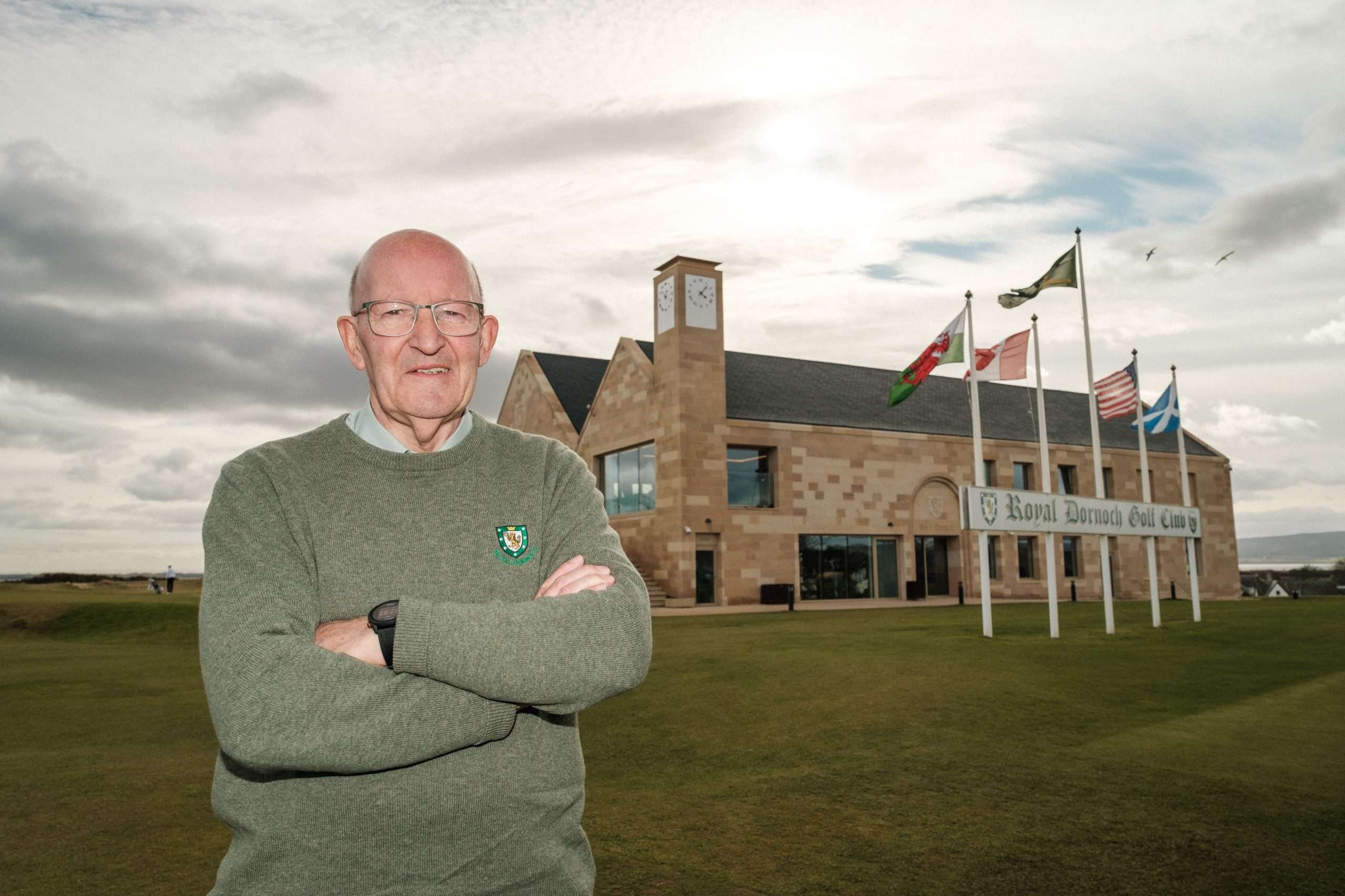 2026 Scottish Golf Lifetime Achievement Award winner Willie Mackay poses for a photo outside the new Royal Dornoch clubhouse on March 3, 2026. (Photos Chris Young/Scottish Golf).